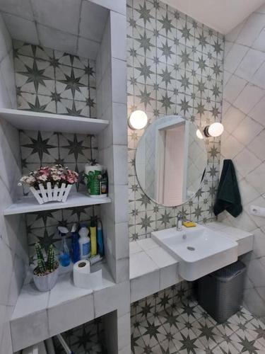 a bathroom with a sink and a mirror at Morkinali Apartment in Tbilisi City