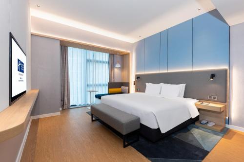 a hotel room with a bed and a television at Holiday Inn Express Nanchang Riverside by IHG in Nanchang