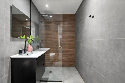 a bathroom with a shower and a sink and a mirror at Renovated apt on Frishman beach with Bomb Shelter M8 in Tel Aviv