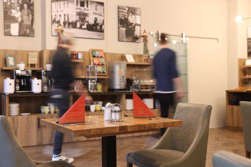 a table with red paper on it in a restaurant at Hotel Blie, Bed & Breakfast, Self Check-in in Horn