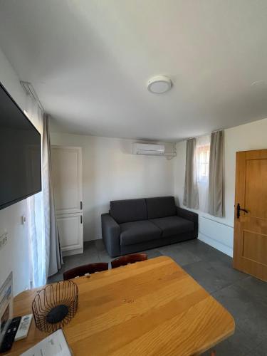 a living room with a couch and a table at Apartments Prekmurska vas - Vital Resort in Moravske Toplice