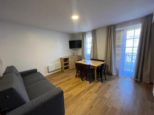 a living room with a couch and a table at Apartments Prekmurska vas - Vital Resort in Moravske Toplice