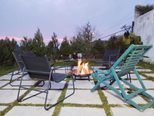 a patio with three chairs and a fire pit at Boutique Hotel Sleep and Wine in Batumi