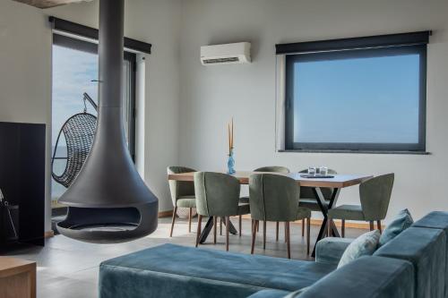 a living room with a couch and a fire place at Villas do Mar in Faja Grande