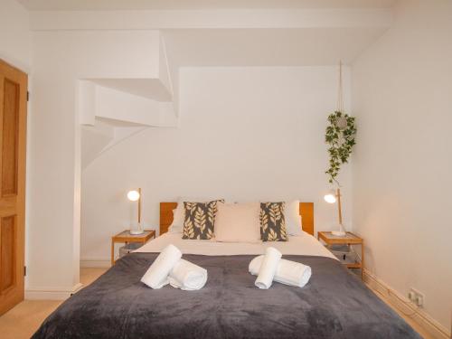 a bedroom with a large bed with two pillows at Owl's Rest in Weymouth