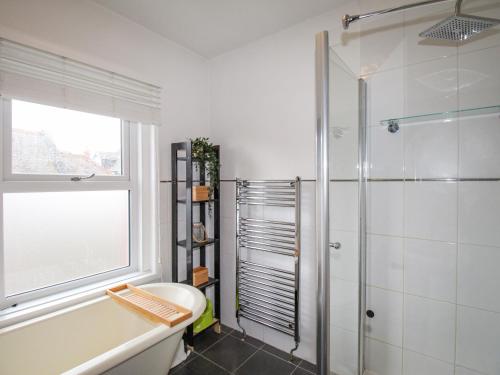 a bathroom with a shower and a toilet and a sink at Owl's Rest in Weymouth