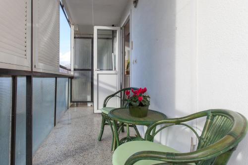 a table and chairs in a room with a refrigerator at Apartment Fabris in Split