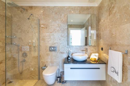 a bathroom with a toilet and a sink and a shower at Villa Moonshine Fantastic View Large Privat Pool in Kalkan