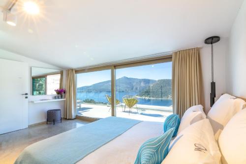 a bedroom with a bed and a large window at Villa Moonshine Fantastic View Large Privat Pool in Kalkan