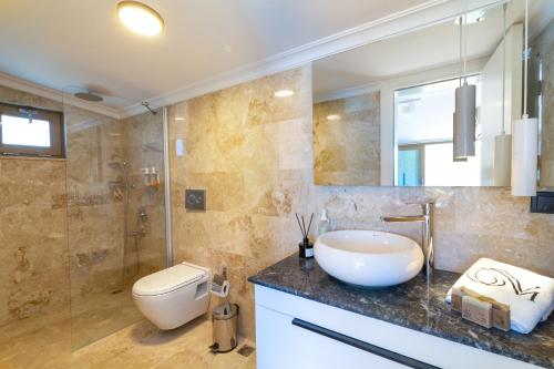 a bathroom with a sink and a toilet at Villa Moonshine Fantastic View Large Privat Pool in Kalkan