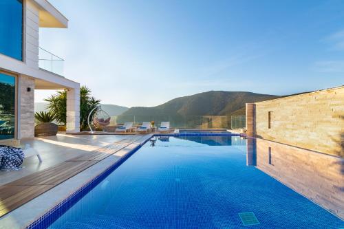 a swimming pool with a view of a house at Villa Moonshine Fantastic View Large Privat Pool in Kalkan