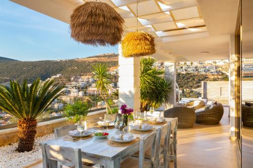 a dining room with a table and views of the city at Villa Moonshine Fantastic View Large Privat Pool in Kalkan