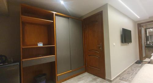 a room with a closet with a sliding glass door at Garden City Plaza Hotel in Cairo