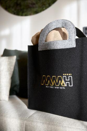 a black bag sitting on top of a couch at Movi Family Apart-Hotel ****s in Corvara in Badia