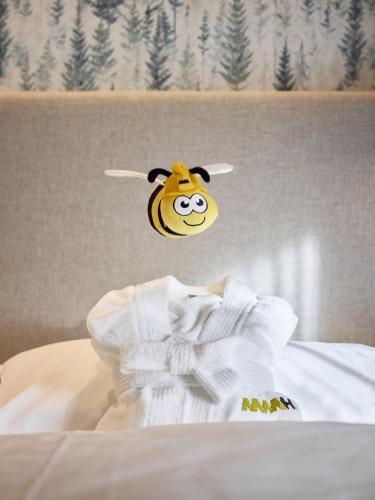 a stuffed cow head is hanging over a bed at Movi Family Apart-Hotel ****s in Corvara in Badia