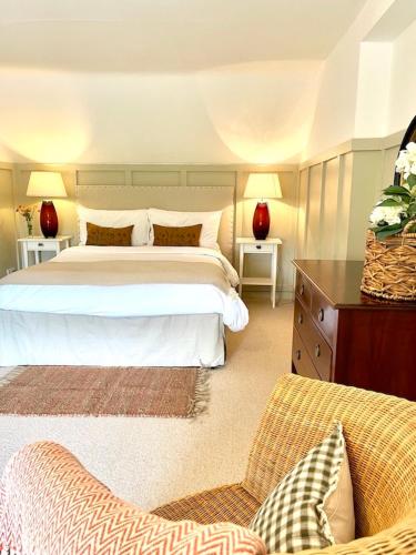 a bedroom with a large bed and a couch at The Stable, Yew Tree Farm Holidays, Tattenhall, Chester in Chester