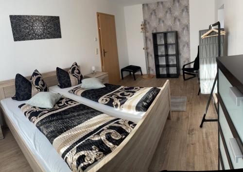 a bedroom with a large bed with a blanket at Ferienwohnung Klitzschen Nähe Torgau in Mockrehna