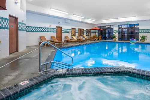 a large pool with blue water in a hotel room at Wood River Inn & Suite in Hailey