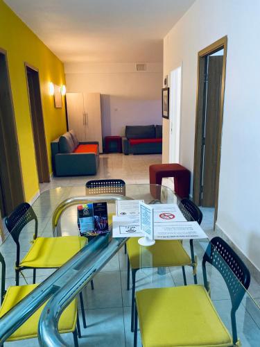 a glass table and chairs in a room at Royal Accommodation in Bucharest