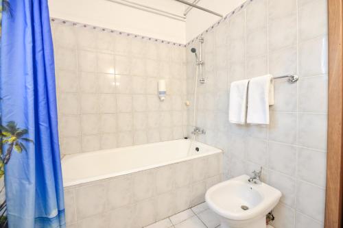 a bathroom with a tub and a toilet and a sink at Royal Accommodation in Bucharest