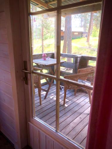 a screened in porch with a table and a bench at Tofvehults Boende in Skaftet