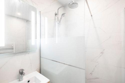 a white bathroom with a shower and a sink at SAINT GERMAIN DES PRÈS - Best Location in Paris