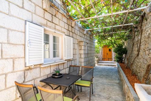 a patio with a table and chairs and a building at Villa Vista Old Town in Cavtat