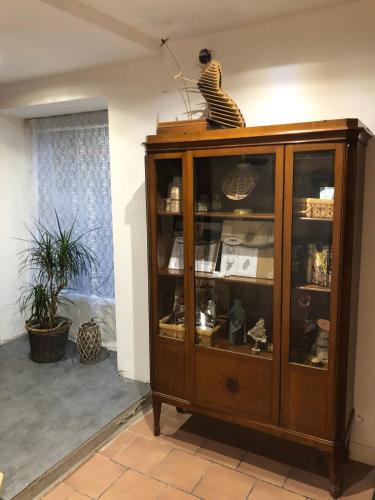a wooden cabinet with glass doors in a room at Accomodatie in Villa Werschmatt in Kruth
