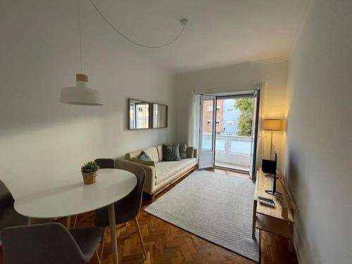 a living room with a couch and a table at ASF Home in Lisbon