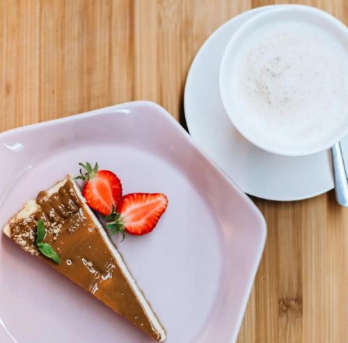 a piece of chocolate cake on a plate with a cup of coffee at Domowa- Restauracja i Pokoje in Wielen Zaobrzanski
