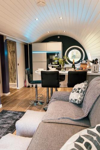 a kitchen and living room with a table and chairs at Hollins Farm - Dog Friendly, Self Catering Holiday Lodges in Knaresborough