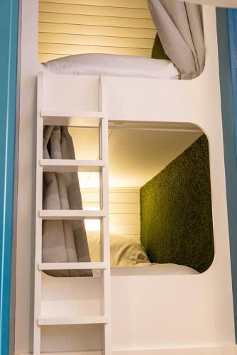 two bunk beds in a room with a bed at Hollins Farm - Dog Friendly, Self Catering Holiday Lodges in Knaresborough