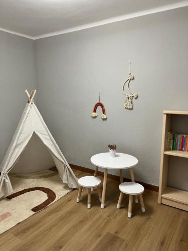 a room with a tent and a table and chairs at Cals iaios in Villalba dels Arcs