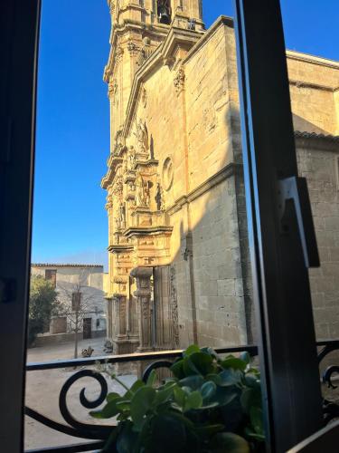 a window view of a building with a clock tower at Cals iaios in Villalba dels Arcs