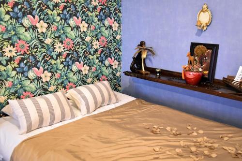 1 dormitorio con 1 cama y papel pintado con motivos florales en Blumen Apartment, en Budapest