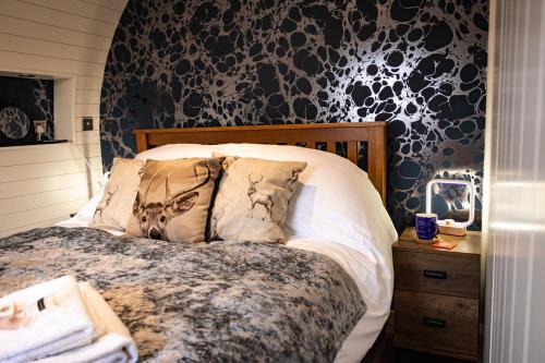 a bedroom with a bed with a black and white wallpaper at Hollins Farm - Dog Friendly, Self Catering Holiday Lodges in Knaresborough