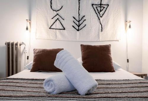 a bed with a towel animal on top of it at Résidence Aristide Briand - Appartements en Centre Ville in Vichy