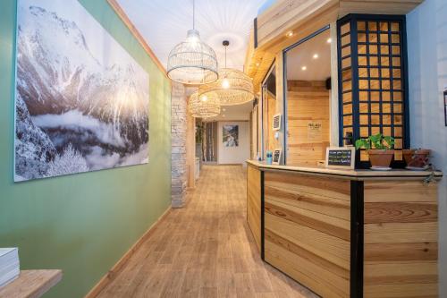 a lobby with a reception desk and a painting on the wall at Hotel Les Lutins in Les Deux Alpes