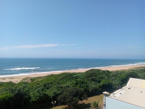 a view of a beach and the ocean at Amanzimtoti Afsaal Holiday Letting in Amanzimtoti