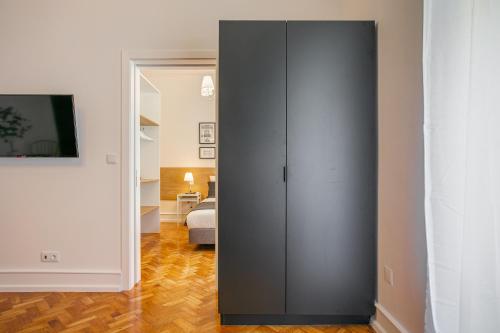 a gray cabinet in a room with a bed at Home Out Rooms & Apartments in Lisbon