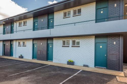 un edificio con puertas azules en un aparcamiento en Comfort Inn All Seasons, en Ballina