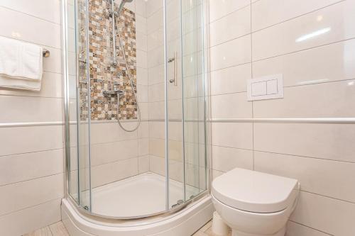 a bathroom with a shower and a toilet at Apartments Crnekovic Tomislava 8 in Baška