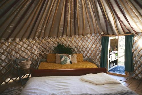 a bedroom with a bed in a yurt at Raven Yurt - Yurtopia in Aberystwyth