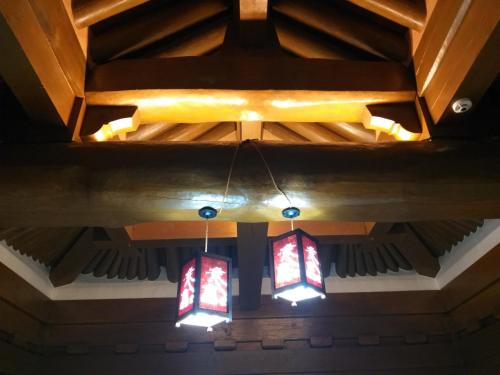 a coffered ceiling with three stained glass windows at HanokInn in Gyeongju