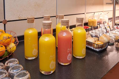 a group of bottles of orange juice sitting on a counter at Businesshotel Forum Widnau in Widnau