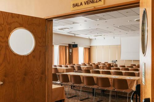 an empty lecture hall with chairs and a podium at Hotel Roma in Lisbon