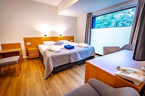 una habitación con 2 camas y un teléfono. en Eva Park Life & Spa, en Konstancin-Jeziorna