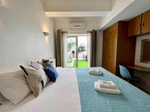 a bedroom with a bed with two towels on it at Albufeira Stylish by Homing in Albufeira