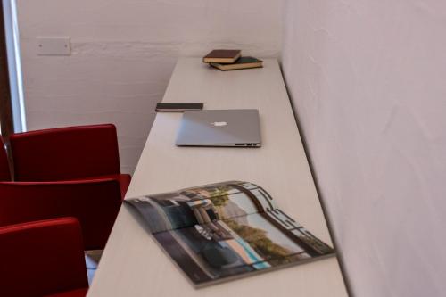 a long table in a room with a laptop on it at Karama in Dorgali