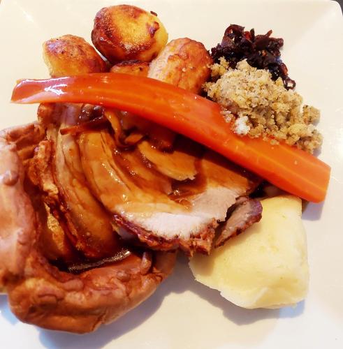 a plate of food with meat and vegetables on it at The Black Lion Royal Hotel in Lampeter